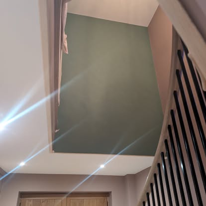 Stairwell with sage green and mauve feature walls